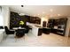 A modern kitchen with dark cabinets, a central island, and a stylish dining area with unique wall decor at 812 Graeme Dr, Mcdonough, GA 30252
