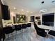 Open-concept kitchen with island seating, modern lighting, and sleek countertops at 812 Graeme Dr, Mcdonough, GA 30252