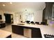 Close-up of kitchen island featuring quartz countertops, stainless steel appliances, and black cabinetry at 812 Graeme Dr, Mcdonough, GA 30252