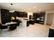 A modern kitchen with dark cabinets, a central island, and a stylish dining area with unique wall decor at 812 Graeme Dr, Mcdonough, GA 30252