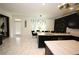 Modern kitchen with marble floors, quartz countertops, black cabinets, and stainless steel appliances at 812 Graeme Dr, Mcdonough, GA 30252