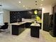 Modern kitchen with an island, black cabinets, marble floors, and updated appliances at 812 Graeme Dr, Mcdonough, GA 30252