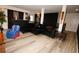 A stylish living room with a sleek black sectional sofa, unique decor, and elegant lighting fixture at 812 Graeme Dr, Mcdonough, GA 30252