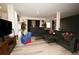 A stylish living room with a sleek black sectional sofa, unique decor, and elegant lighting fixture at 812 Graeme Dr, Mcdonough, GA 30252