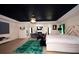 This is a large main bedroom with a sitting area, fireplace, exercise equipment, and an ensuite bathroom at 812 Graeme Dr, Mcdonough, GA 30252