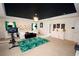 This is a large main bedroom with a king bed, ensuite bathroom, and exercise equipment at 812 Graeme Dr, Mcdonough, GA 30252