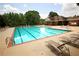 A community pool with clear blue water and plenty of seating on a sunny day at 812 Graeme Dr, Mcdonough, GA 30252