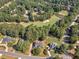 Stunning aerial view of home, golf course and pond surrounded by lush trees at 925 Champions Way, Mcdonough, GA 30252