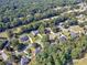 Stunning aerial view of home surrounded by lush trees in desirable neighborhood at 925 Champions Way, Mcdonough, GA 30252