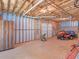 Unfinished basement with a lawnmower, a garage door, and equipment at 925 Champions Way, Mcdonough, GA 30252