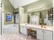 An elegant bathroom featuring a garden tub, double vanity, and ample lighting at 925 Champions Way, Mcdonough, GA 30252