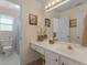 Bright bathroom featuring vanity, sink, and toilet at 925 Champions Way, Mcdonough, GA 30252