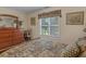 Cozy bedroom with dresser, window, and bed at 925 Champions Way, Mcdonough, GA 30252
