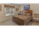 Comfortable bedroom with a wooden bed frame and a window at 925 Champions Way, Mcdonough, GA 30252
