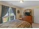 Bedroom with a window, dresser, and mirror at 925 Champions Way, Mcdonough, GA 30252