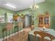 Open-concept dining area with bar seating, a view of the kitchen, and stylish overhead lighting at 925 Champions Way, Mcdonough, GA 30252