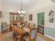 Elegant dining room with a chandelier, wooden table, and seating for six at 925 Champions Way, Mcdonough, GA 30252