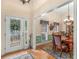 Elegant foyer with hardwood floors, decorative front door, and open view to the dining area at 925 Champions Way, Mcdonough, GA 30252