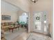 Inviting foyer with hardwood floors, a decorative front door, and views into the living room at 925 Champions Way, Mcdonough, GA 30252