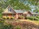 Charming single-story brick home featuring lush landscaping and an inviting front entrance at 925 Champions Way, Mcdonough, GA 30252