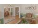 Inviting hallway leading to the dining room, with hardwood floors and decorative accents at 925 Champions Way, Mcdonough, GA 30252