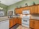 Spacious kitchen featuring granite countertops, a microwave, and light wood cabinetry at 925 Champions Way, Mcdonough, GA 30252
