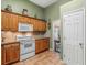 Classic kitchen featuring wooden cabinets, granite countertops, and white appliances at 925 Champions Way, Mcdonough, GA 30252
