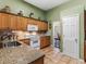 Well-equipped kitchen with granite countertops, white appliances, and ample cabinet space at 925 Champions Way, Mcdonough, GA 30252