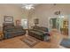 Open living area with hardwood floors, comfortable couches, and access to other rooms at 925 Champions Way, Mcdonough, GA 30252