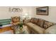 Cozy living room featuring a floral armchair and a patterned sofa with throw pillows at 925 Champions Way, Mcdonough, GA 30252