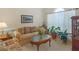 Cozy living room featuring comfortable seating, a large window with sheer curtains, and decor at 925 Champions Way, Mcdonough, GA 30252