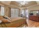Main bedroom with large windows, hardwood floors, and a four-poster bed with a luxurious mattress at 925 Champions Way, Mcdonough, GA 30252