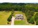 Grand aerial view of home, showcasing landscaping, long driveway, and surrounding nature at 127 Grayson Myers Dr, Villa Rica, GA 30180