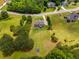 Beautiful aerial view showcases the home's location amidst lush greenery, other homes, and winding roads at 127 Grayson Myers Dr, Villa Rica, GA 30180