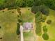 Expansive aerial view captures the sprawling grounds, lush trees, and stunning home nestled in a serene setting at 127 Grayson Myers Dr, Villa Rica, GA 30180