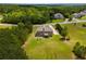 Picturesque aerial view highlights a home set back on a large, green lot with surrounding mature trees at 127 Grayson Myers Dr, Villa Rica, GA 30180