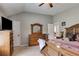 Neutral bedroom with vaulted ceiling, fan, and a wooden dresser with mirror at 127 Grayson Myers Dr, Villa Rica, GA 30180