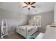 Cozy bedroom featuring neutral walls, a white wood bed frame and accents, and a ceiling fan at 127 Grayson Myers Dr, Villa Rica, GA 30180