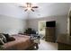 Bedroom featuring vaulted ceiling, fan, tv, with view to backyard at 127 Grayson Myers Dr, Villa Rica, GA 30180