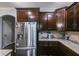 Modern kitchen with stainless steel refrigerator, granite countertops, and dark cabinetry, providing a functional cooking space at 127 Grayson Myers Dr, Villa Rica, GA 30180