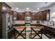 Beautiful kitchen with dark cabinets, granite countertops, and stainless steel appliances for modern cooking at 127 Grayson Myers Dr, Villa Rica, GA 30180