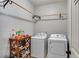 Practical laundry room with washer, dryer, and storage racks, designed for efficient and convenient chore management at 127 Grayson Myers Dr, Villa Rica, GA 30180