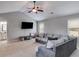 Spacious living room featuring vaulted ceilings, fan, carpet and a comfortable sectional sofa at 127 Grayson Myers Dr, Villa Rica, GA 30180