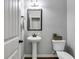 Cozy powder room with pedestal sink and decorative mirror at 127 Grayson Myers Dr, Villa Rica, GA 30180