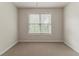 Neutral bedroom with a window offering natural light and views of the outdoors at 3717 Lockerbie Ln, Powder Springs, GA 30127
