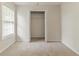 Bright bedroom featuring neutral carpet and a closet with bi-fold doors at 3717 Lockerbie Ln, Powder Springs, GA 30127