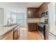 Modern kitchen boasts stainless steel appliances, granite countertops, and dark wood cabinetry at 3717 Lockerbie Ln, Powder Springs, GA 30127