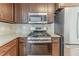 Well-equipped kitchen featuring a gas range, stainless steel appliances, and granite countertops at 3717 Lockerbie Ln, Powder Springs, GA 30127