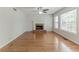 Spacious living room featuring a fireplace, hardwood floors and abundant natural light at 3717 Lockerbie Ln, Powder Springs, GA 30127