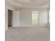 Large main bedroom featuring a tray ceiling, neutral carpet, and access to the main bath at 3717 Lockerbie Ln, Powder Springs, GA 30127
